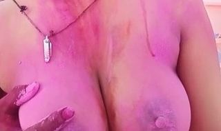 Husband is Playing with the big boobs of his pregnant wife during Holi